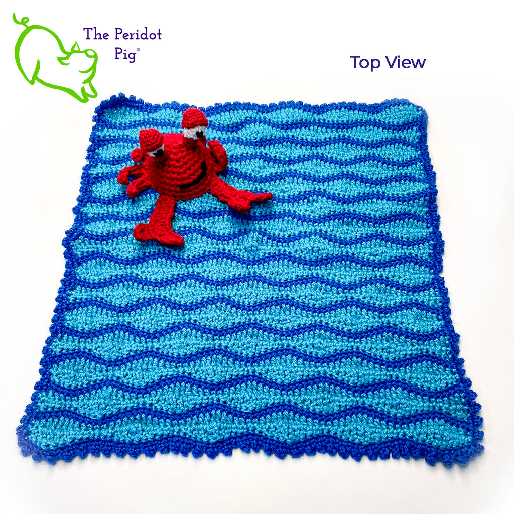 Cliff the Crab is featured on this cute security blanket! Some think he can be a bit terse but he's really the life of the party. Those eyes pop up and just seem to say, "Hellloooooo!" He's hanging out in the waves of a bright blue, Caribbean ocean.  He's made of 100% high, quality acrylic yarn for a really durable blanket. He's sewn onto the blanket which measures 17x18". Perfect for a beach house or an Under the Sea themed room! Top view shown.
