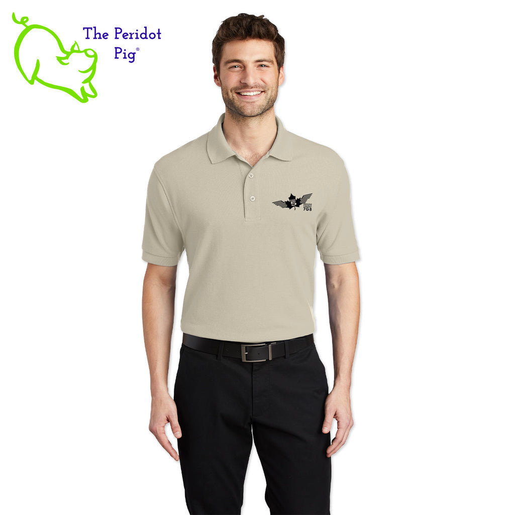 Renowned for its resilience, our incomparably comfortable classic polo is second to none. Expertly designed to resist wrinkles and shrinkage, this must-have polo delivers a luxuriously soft feel. Featuring the iconic EAA Chapter 5 logo on the left chest, you won't ever regret choosing this timeless piece. Front view shown in Stone-Black.