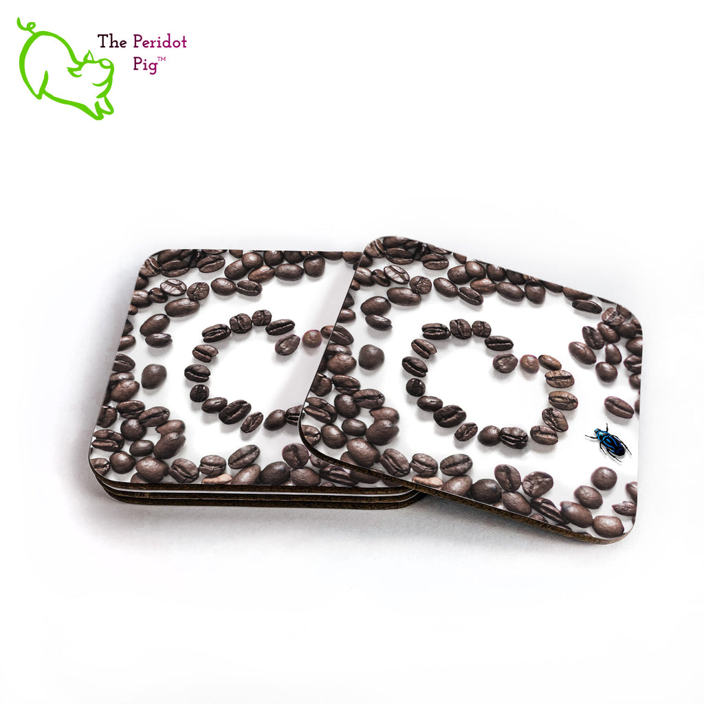 This set of four square coasters is printed with a vivid, detailed image of coffee beans. There's a heart in the middle and a little blue beetle off to the right side. The coasters are printed in a durable ink that won't fade over time. Perfect for both hot and cold beverages. Shown in a stack with one to the side.