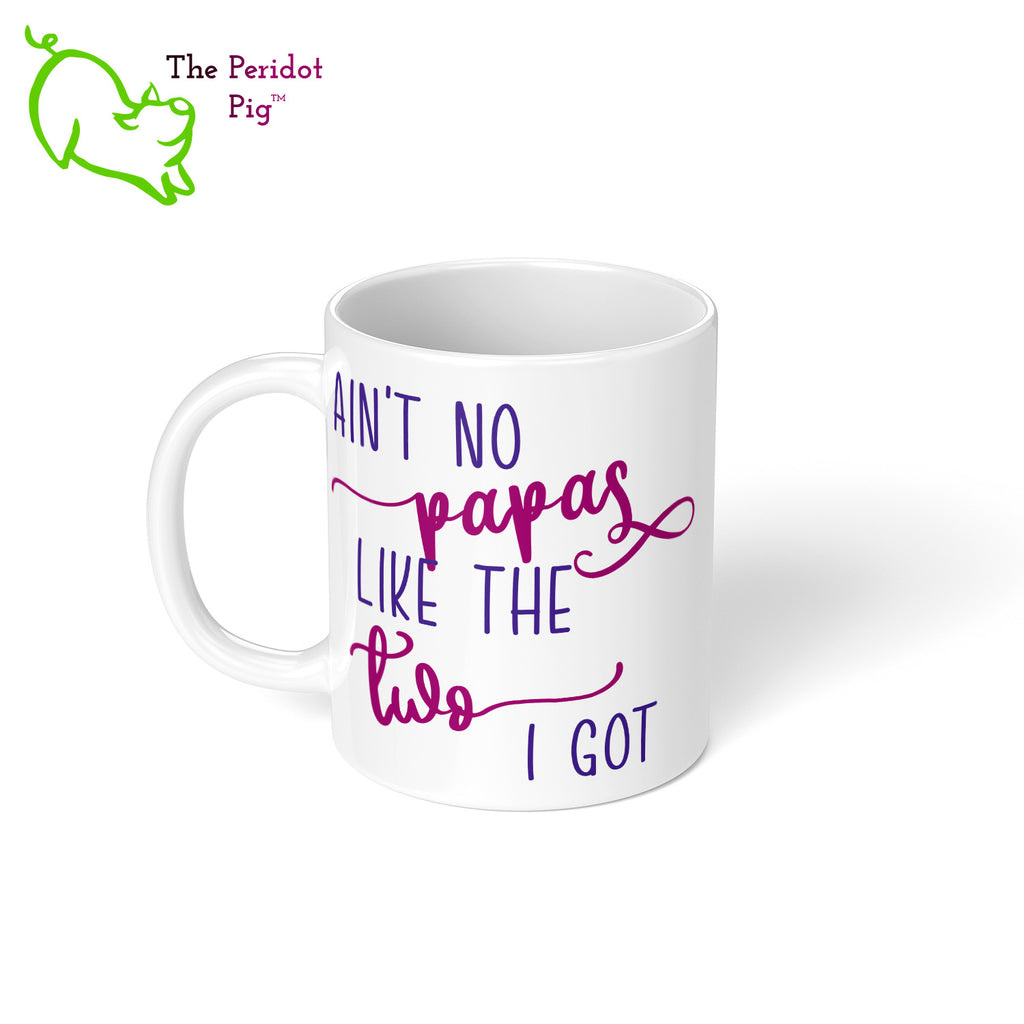 A shout out to our LGTQBA Dads! Celebrate Father's day with a gift that embraces your pride. The mug says, "Ain't no papas like the two I got" on the front. On the back, it has rainbow stripes with the saying, "Love is love". Left view.