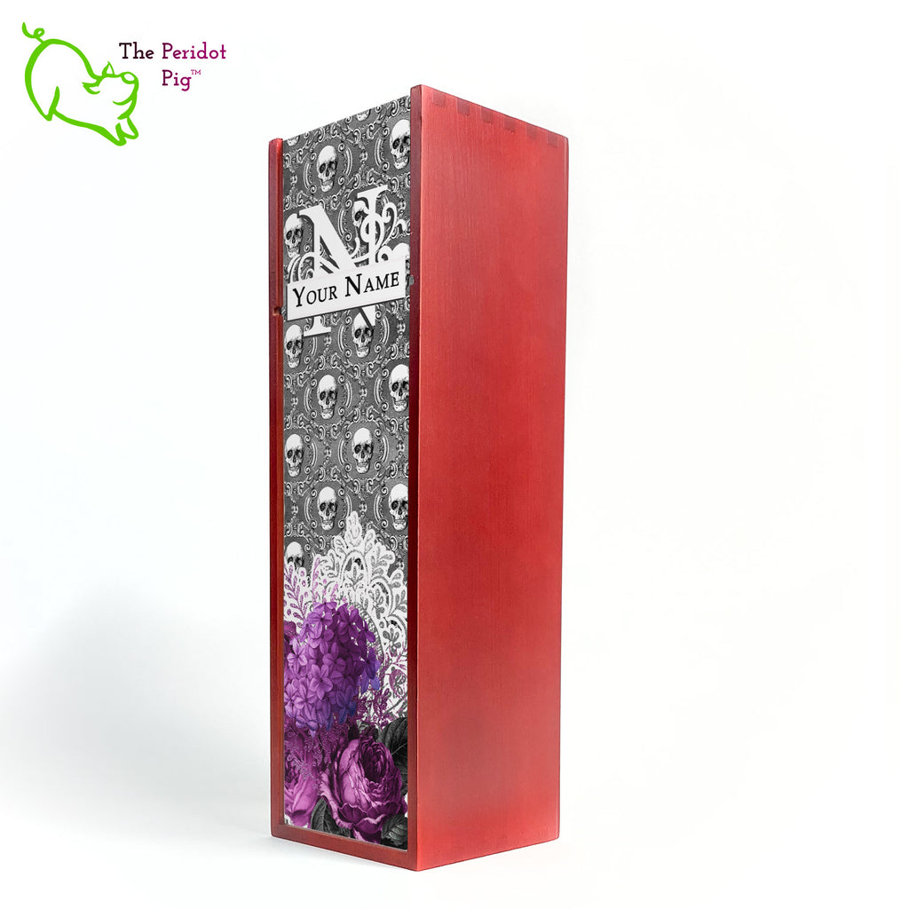 A gift wine box with decorated panel. The front panel is decorated in a glossy, detailed print with a monogram and space for a customized name. This model has a background of Victorian skulls with a bouquet of purple flowers and lace. Shown in cherry finish.