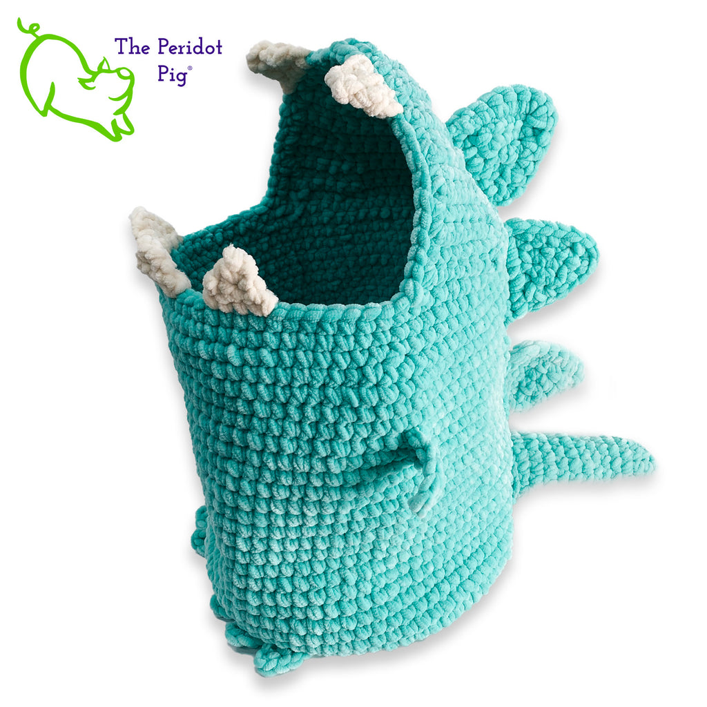 Hear Tiffany roar! Luckily she looks more menacing than reality. She's soft and plush from being made with a soft poly chenille. She just wants a hug but she has these little tiny arms which make it hard. Even her teeth and spikes are soft! As you can see, Tiffany has a big mouth that can hold a lot of toys, towels, clean diapers, even toilet paper (we put in 9 double rolls!). Left view shown.