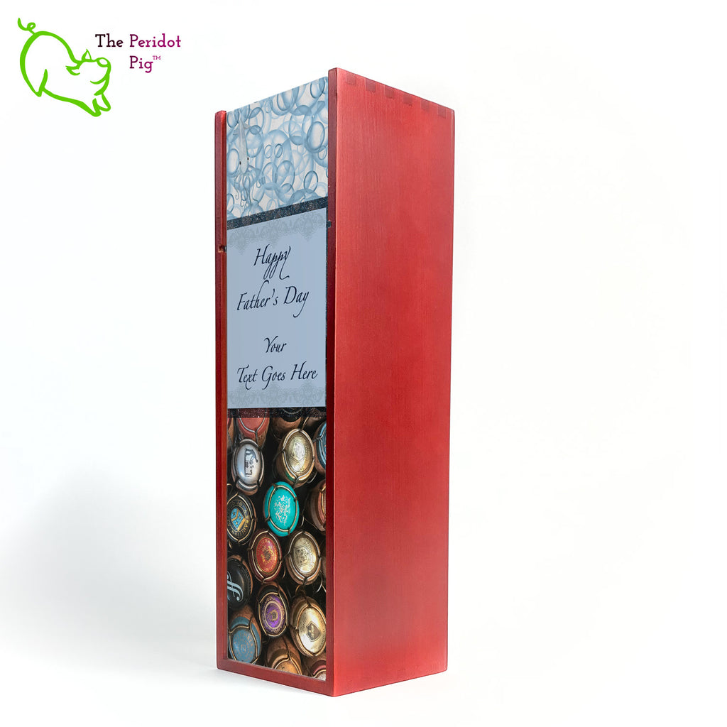 The wine box front panel is decorated in a glossy, detailed print with a space for a customized name(s) and/or a date. This model has a colorful picture of champagne corks on the bottom. The center frame features a field of blue with antique lace and flowing script.  We warned you that we were hiding another little squid and you'll see him peaking from the bubbles at the top of the panel! Happy Father's Day, front closed view in Cherry.