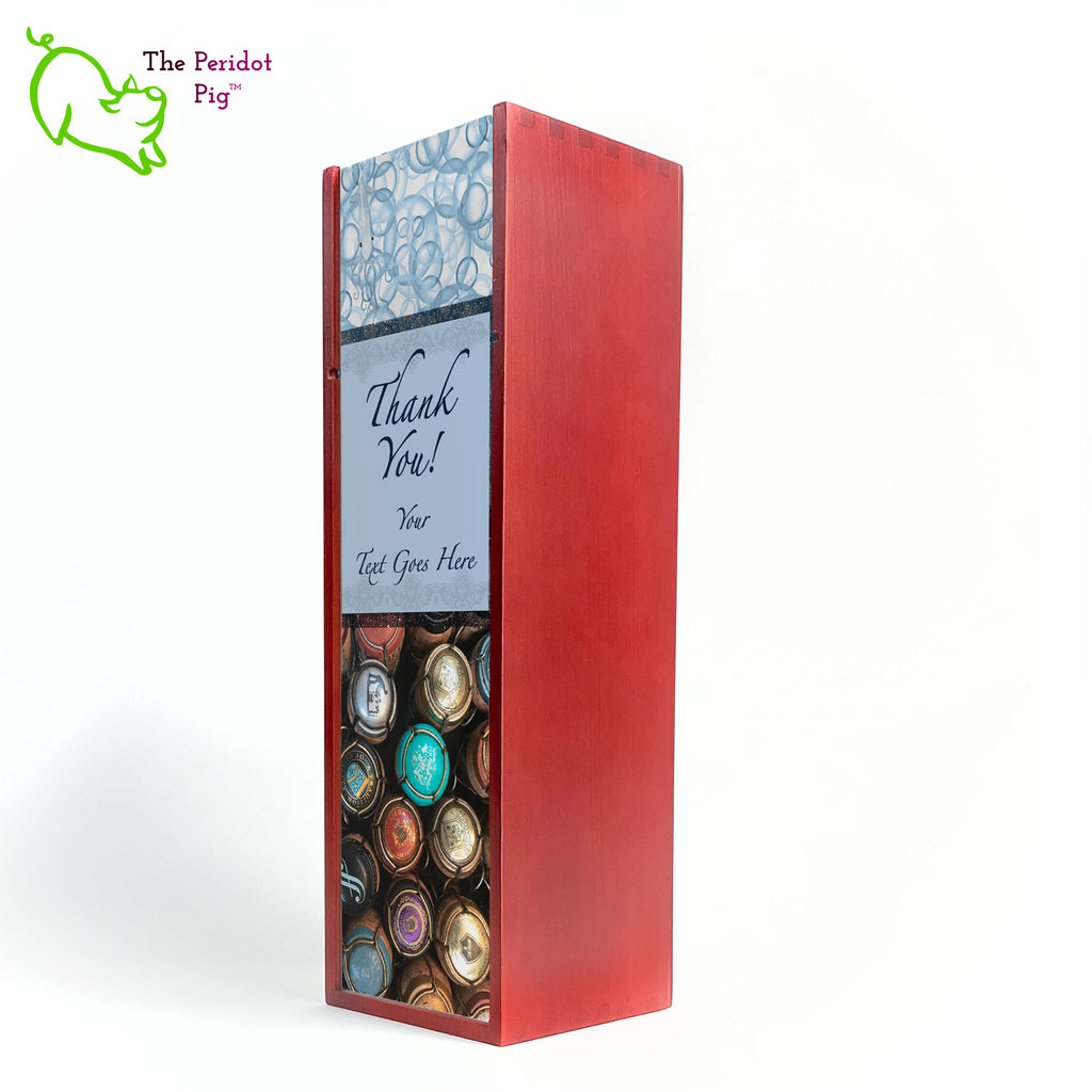 The wine box front panel is decorated in a glossy, detailed print with a space for a customized name(s) and/or a date. This model has a colorful picture of champagne corks on the bottom. The center frame features a field of blue with antique lace and flowing script.  We warned you that we were hiding another little squid and you'll see him peaking from the bubbles at the top of the panel! Thank You!, front closed view in Cherry.