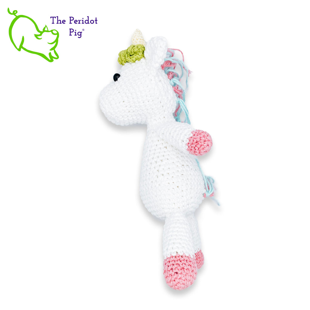 Lily is my first unicorn amigurumi. She's made of sturdy cotton yarn in white, pink, teal and green. She has a cute little yellow horn with three green flowers surrounding her head. She's a soft, squishy toy but still pretty indestructible and meant to last a life-time.  Left view long shown.