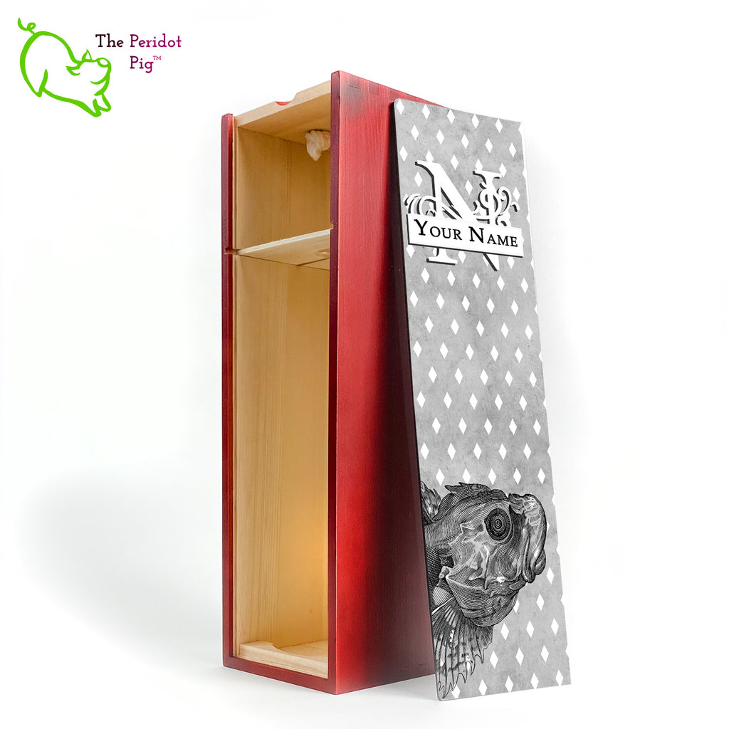The wine box front panel is decorated in a glossy, detailed print with a white monogram and space for a customized name. This model has a smokey gray background with a pattern of white diamond shapes. In the foreground is a large black line drawing of a fish. Cherry finish showing the interior.