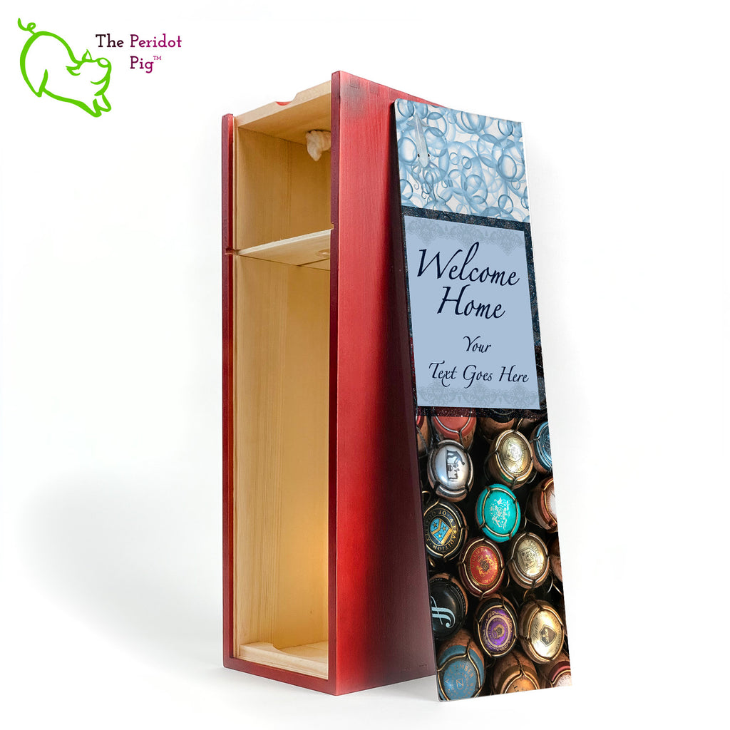 The wine box front panel is decorated in a glossy, detailed print with a space for a customized name(s) and/or a date. This model has a colorful picture of champagne corks on the bottom. The center frame features a field of blue with antique lace and flowing script.  We warned you that we were hiding another little squid and you'll see him peaking from the bubbles at the top of the panel! Welcome Home, front open view in Cherry.