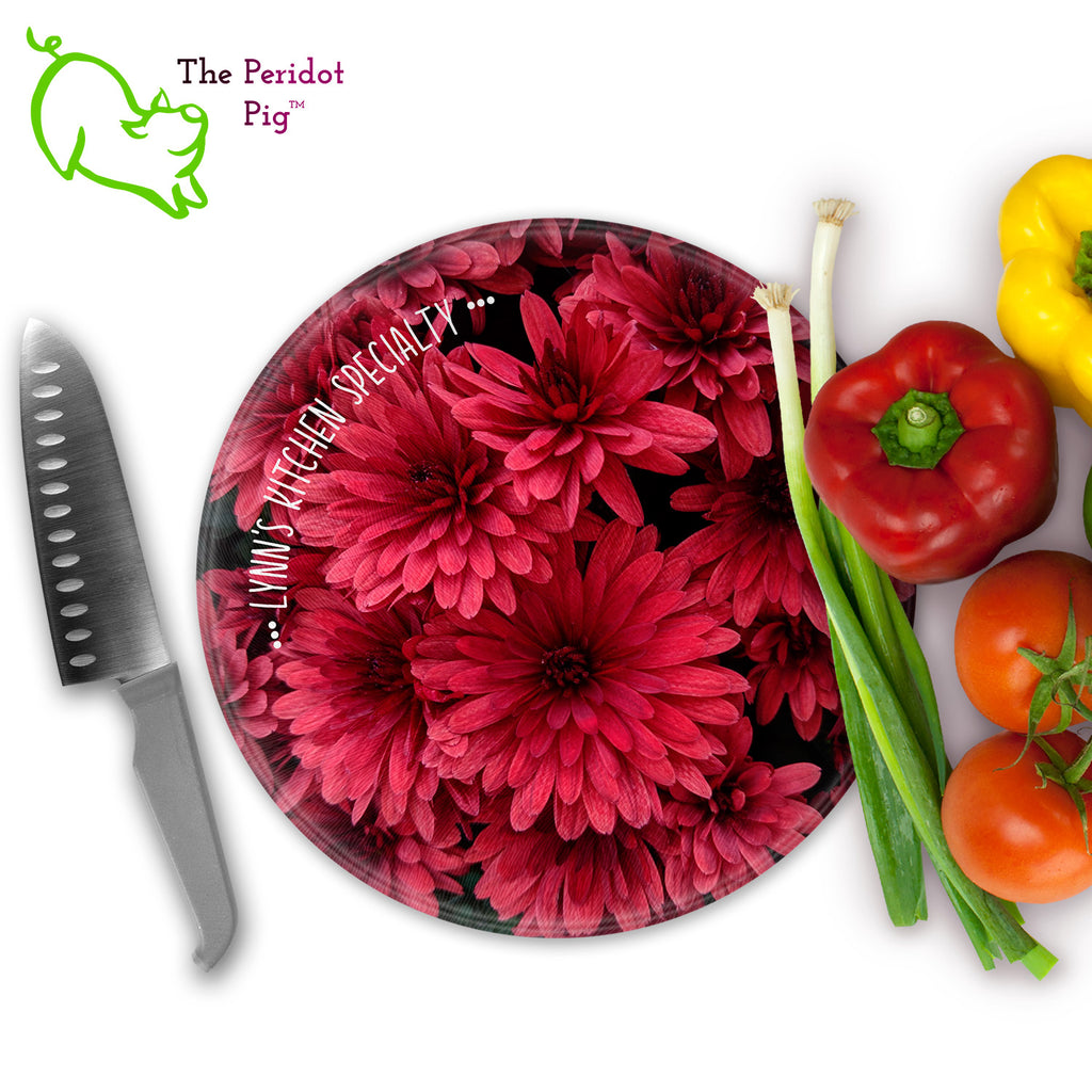 This beautiful tempered glass cutting board is a wonderful keepsake!  It can be personalized with names, quotes or dates. This one features bright pink dahlias in a vivid and detailed print. Perfect for cutting or using as a serving board! Front view with veggies.