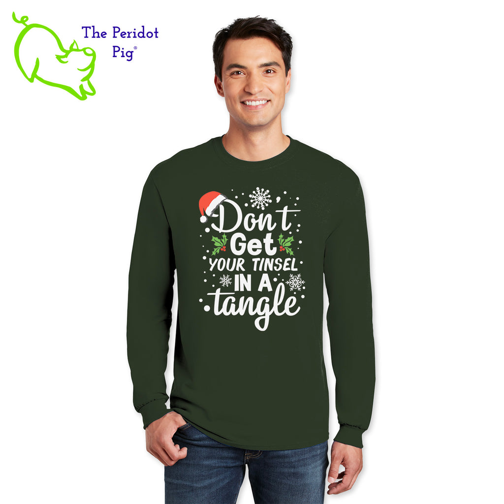 The holidays can be stressful for some. Tell them to chill out with our favorite 100% long sleeve cotton tee. The front says, "Don't get your tinsel in a tangle" in bright festive colors. There are holly berries, a jaunty Santa hat and snow flakes to round out the design. The back is undecorated. Front view shown in Forest Green.