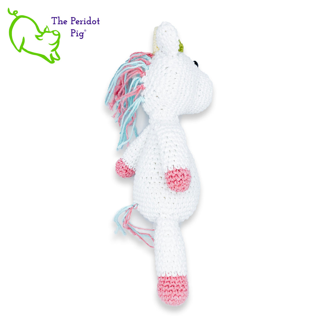 Lily is my first unicorn amigurumi. She's made of sturdy cotton yarn in white, pink, teal and green. She has a cute little yellow horn with three green flowers surrounding her head. She's a soft, squishy toy but still pretty indestructible and meant to last a life-time.  Right view long shown.