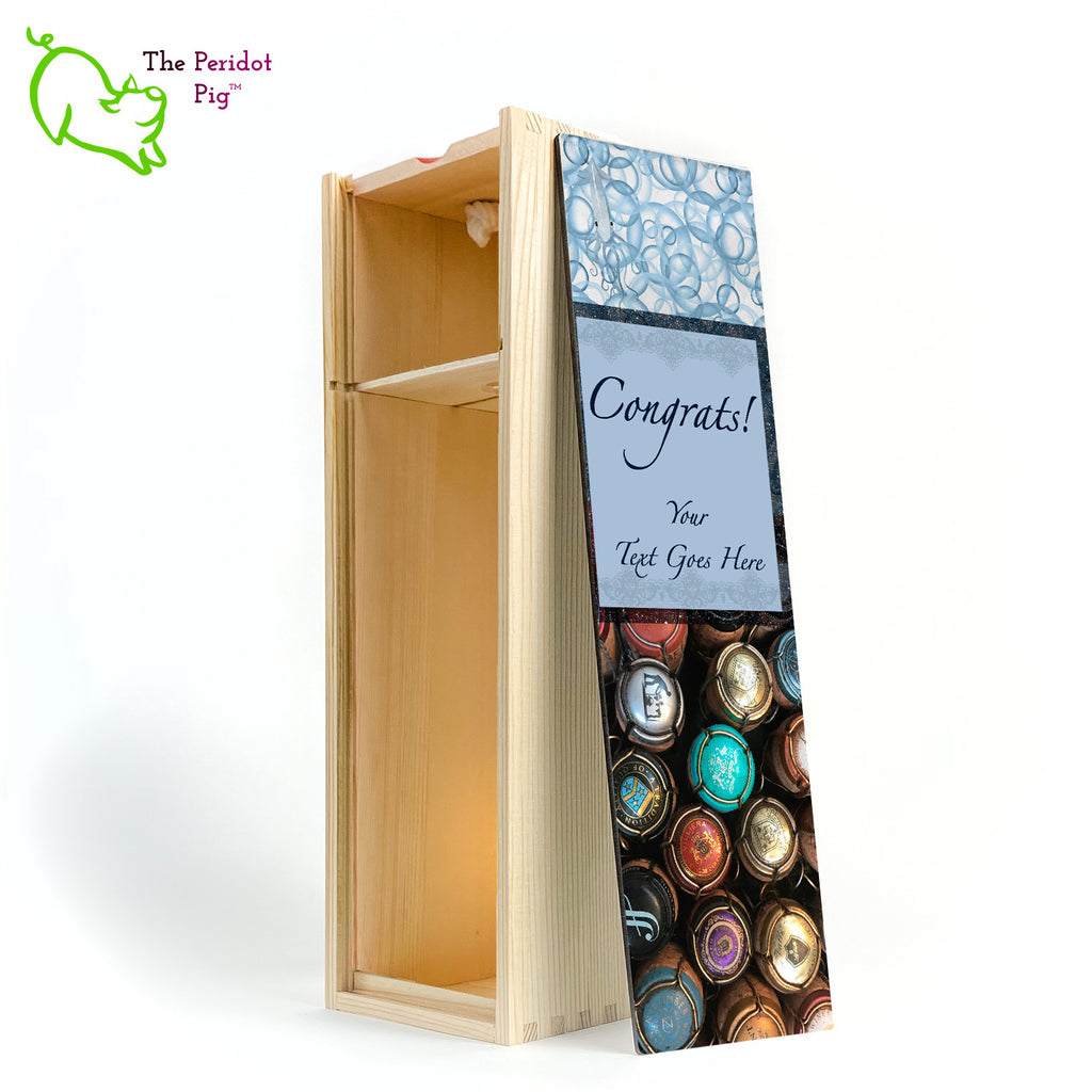 The wine box front panel is decorated in a glossy, detailed print with a space for a customized name(s) and/or a date. This model has a colorful picture of champagne corks on the bottom. The center frame features a field of blue with antique lace and flowing script.  We warned you that we were hiding another little squid and you'll see him peaking from the bubbles at the top of the panel! Congrats, front open view in Natural.