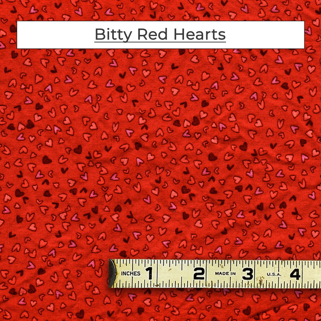 Show your love with a mask featuring little hearts in red, pink, purple and orange on a red background. Called Bitty Red Hearts