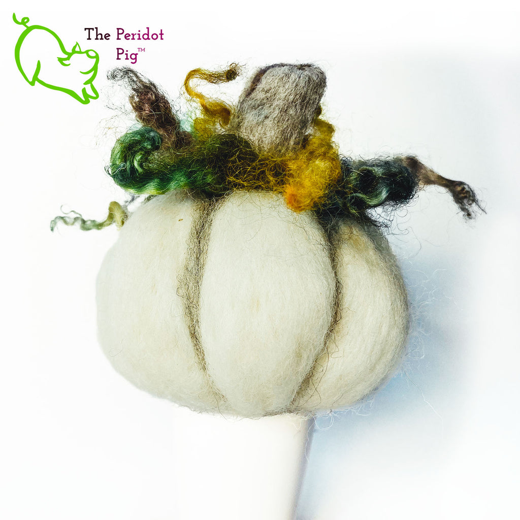 Just in time for the Halloween season, we're offering these one-of-a-kind pumpkins.  We call them PolterPumpkins due to their ghostly, grotesque inspired faces. Each one is unique and hand-made from needle felted 100% wool. The pumpkin measures about 4-5" wide and around 4-5" tall.  The body is crafted in white wool with the face in a stony gray. Multi-color locks simulate a little vine growth at the top. Back view - Geoff.