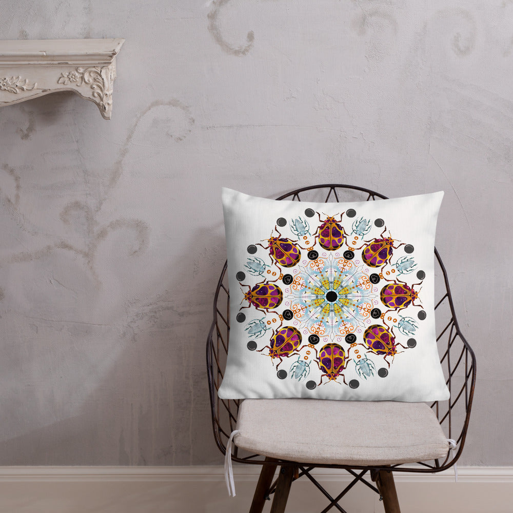 A colorful mandala of beetles graces this white pillow. The larger beetle has shades of violet surrounded by gold. The smaller beetle is in a delicate shade of blue. Printed on a bright, white casing these bugs really pop! Shown in size 22"x22".