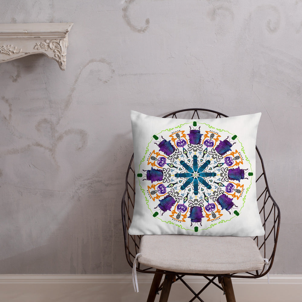 A colorful mandala of beetles graces this white pillow and is availble in either 18"x18" or 22"x22" sizes. The image is printed on both the front and back. The larger beetle has shades of violet and blue. Shown in size 22x22 on a chair
