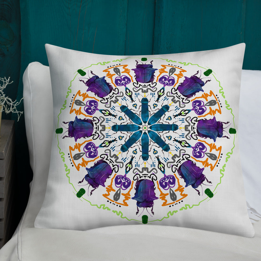 A colorful mandala of beetles graces this white pillow and is availble in either 18"x18" or 22"x22" sizes. The image is printed on both the front and back. The larger beetle has shades of violet and blue. Shown in size 22x22 on a bed