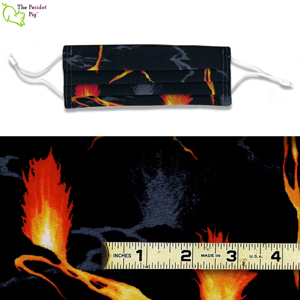 A view showing the mask and the scale of the pattern. A mixed color fabric with orange and yellow lava flows on a black background. Called Lava Flow