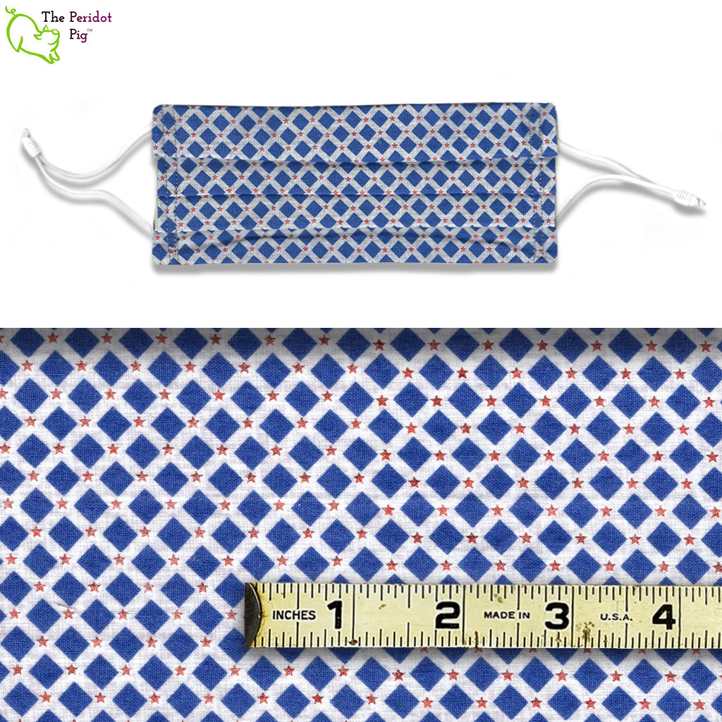 A view showing the mask and the scale of the pattern. Fabric pattern with blue diamonds on a white background with small red foil stars.  Called Patriotic